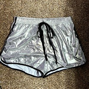 Metallic silver colored shorts. Elastic waist band. Size medium